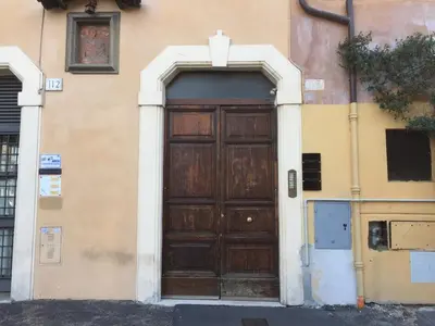 a large wooden door on a building at Livia B&B - Trastevere in Rome