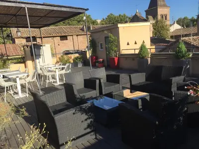 a patio with chairs and tables on a roof at Livia B&B - Trastevere in Rome