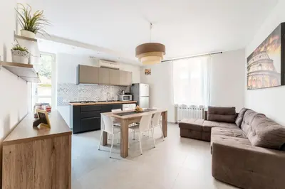 a kitchen and living room with a couch and a table at FL Apartments Il piccolo borgo di Trastevere in Rome