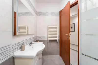 a bathroom with a sink and a mirror at FL Apartments Il piccolo borgo di Trastevere in Rome