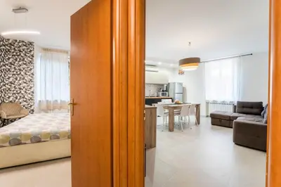 a bedroom and living room with a bed and a kitchen at FL Apartments Il piccolo borgo di Trastevere in Rome