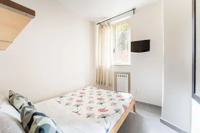 a small bedroom with a bed and a window at FL Apartments Il piccolo borgo di Trastevere in Rome