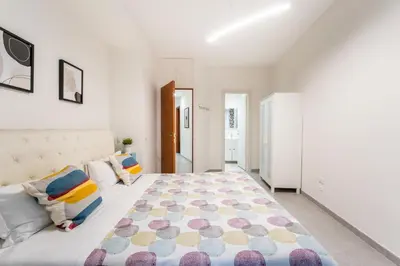 a bedroom with a large bed with a rug on the floor at FL Apartments Il piccolo borgo di Trastevere in Rome