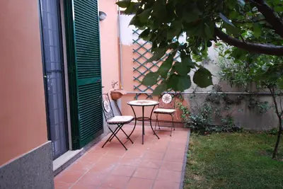 a patio with two chairs and a table in a yard at L'Oasi al Pigneto - Guest house in Rome