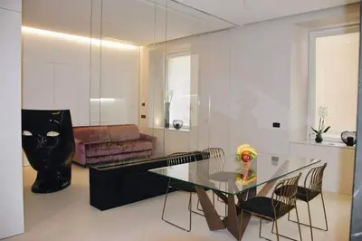 a living room with a glass table and a couch at LuMa Suite Via Veneto - Your luxury style 29 in Rome