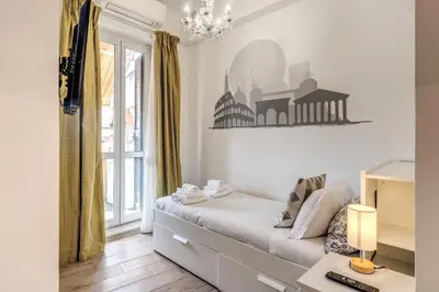 a small bedroom with a bed and a window at Domus Heroas near Vatican in Rome