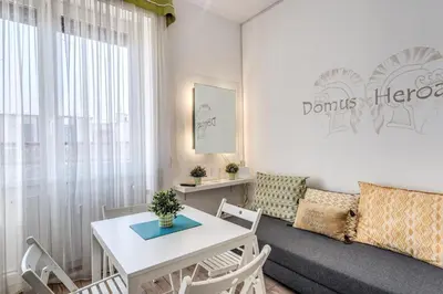 a living room with a table and a couch at Domus Heroas near Vatican in Rome