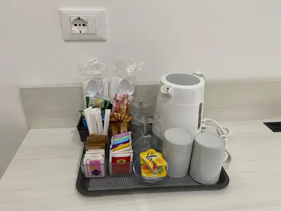 a kitchen counter with a tray with utensils and cups at Residenza Giustiniani in Rome