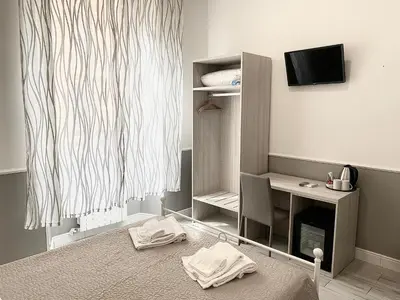 a room with a desk and a chair and a television at Residenza Giustiniani in Rome