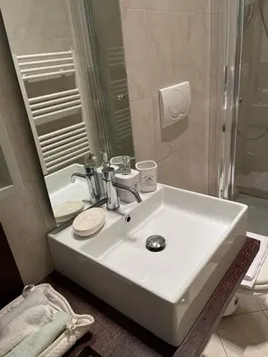 a bathroom with a white sink and a mirror at ColosseoDreamApartment in Rome