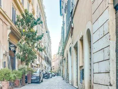 an alley in a city with cars parked at ColosseoDreamApartment in Rome