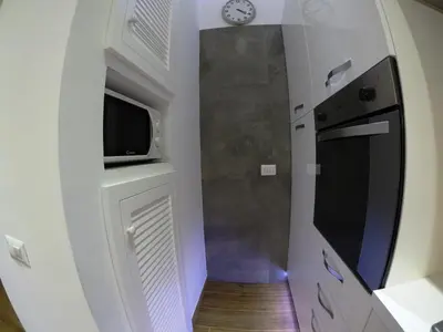 a small kitchen with a sink and a microwave at Poliziano Apartment in Rome