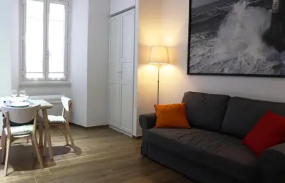 a living room with a couch and a table at Poliziano Apartment in Rome