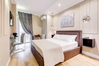 a bedroom with a large bed and a television at Mellini Palace Suites by Premium Suites Collection in Rome