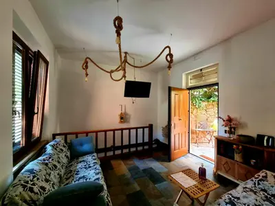 a living room with a couch and a tv at La Casa nel Borgo in Rome