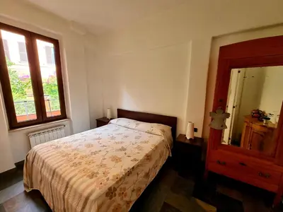 a bedroom with a bed and a large mirror at La Casa nel Borgo in Rome