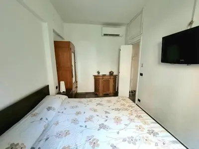 a bedroom with a bed and a tv on the wall at La Casa nel Borgo in Rome