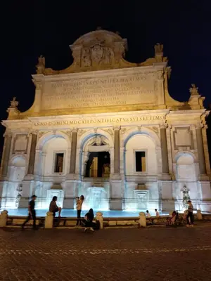 a building with people standing in front of it at night at La Casa nel Borgo in Rome