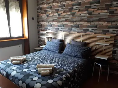a bedroom with a bed with a brick wall at B&B Papa Leone Countryrooms in Rome