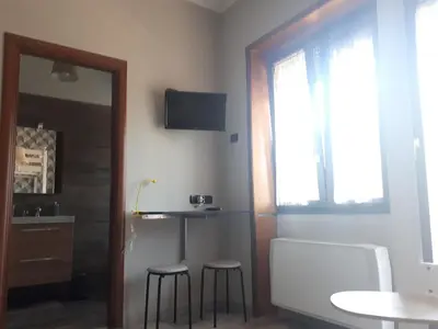 a room with two stools and a table and a mirror at B&B Papa Leone Countryrooms in Rome