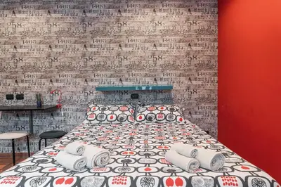 a bed in a room with a brick wall at B&B Papa Leone Countryrooms in Rome