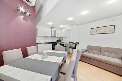 a living room with a table and a couch at Peroni 8 Pax Brand New Apartment in Rome