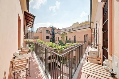 a balcony of a building with benches and plants at Peroni 8 Pax Brand New Apartment in Rome