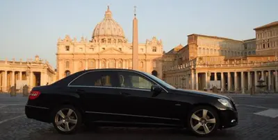 a black car parked in front of a building at Harmony & Comfort at the Vatican Museum in Rome