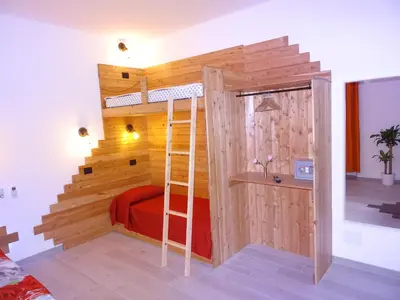 a room with a bunk bed and a ladder at Harmony & Comfort at the Vatican Museum in Rome