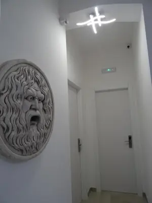 a statue of a head on a wall next to a door at Harmony & Comfort at the Vatican Museum in Rome