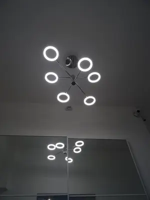 a clock on the ceiling with lights on it at Harmony & Comfort at the Vatican Museum in Rome