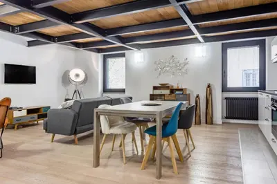 a living room with a table and chairs at Ponte Milvio Luxury House in Rome