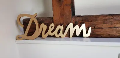 a wooden sign that says mom on a shelf at Ponte Milvio Luxury House in Rome