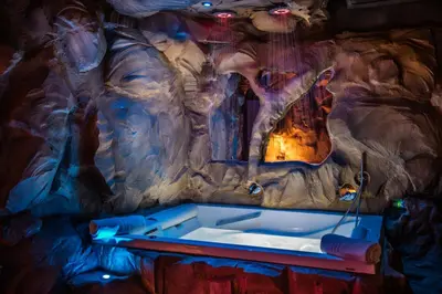 a room with a bath tub in a cave at MagicSuite Guest House Roma Portuense in Rome