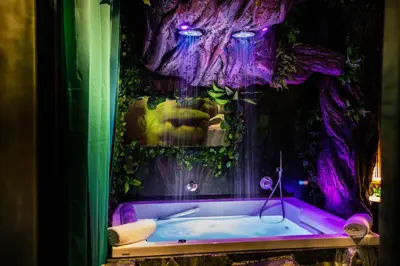 a bathroom with a purple tub with a tree at MagicSuite Guest House Roma Portuense in Rome