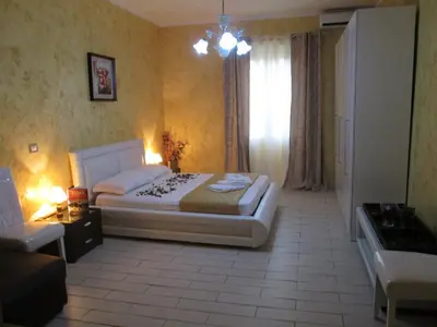 a bedroom with a white bed and a window at VaticanSky rooms in Rome