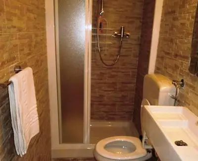 a bathroom with a shower and a toilet and a sink at VaticanSky rooms in Rome