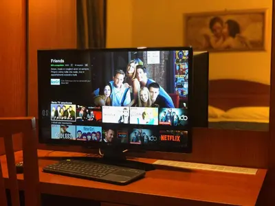 a computer monitor sitting on a desk with a keyboard at Saint Peter Inn in Rome