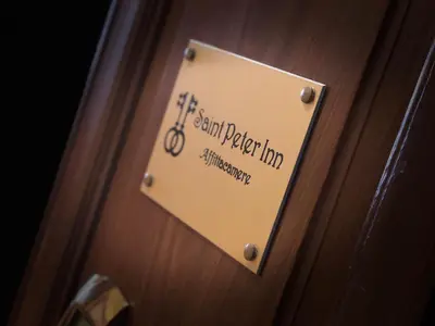 a sign on a door with a bike on it at Saint Peter Inn in Rome