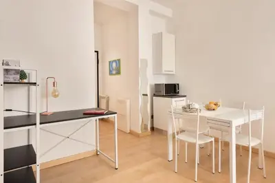 a kitchen with a table and chairs in a room at World Wide Bed San Giovanni in Rome