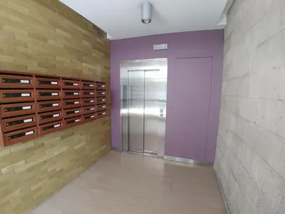 a hallway with a elevator and a door in a wall at World Wide Bed San Giovanni in Rome