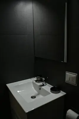 a bathroom with a white sink and a mirror at Empire Suites in Rome