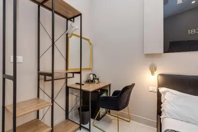 a small room with a desk and a bed at Empire Suites in Rome