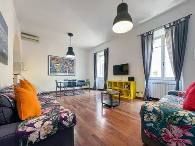 a living room with a couch and a table at JHHIT San Pietro Modern Suite in Rome