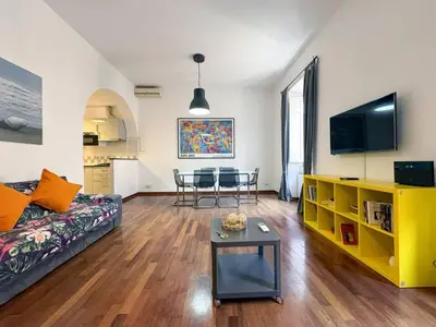 a living room with a couch and a table at JHHIT San Pietro Modern Suite in Rome