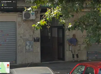 a man standing in the doorway of a building at JHHIT Tuscolana Suite 03 with Terrace in Rome