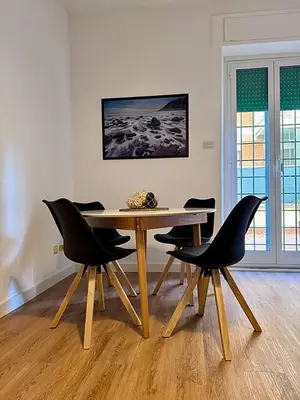 a dining room table and chairs in a room at JHHIT Tuscolana Suite 03 with Terrace in Rome