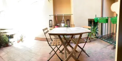 a wooden table and chairs in a room at Urbana Colosseo Boutique Apartment in Rome