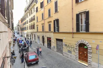 a group of people walking down a street with buildings at Urbana Colosseo Boutique Apartment in Rome