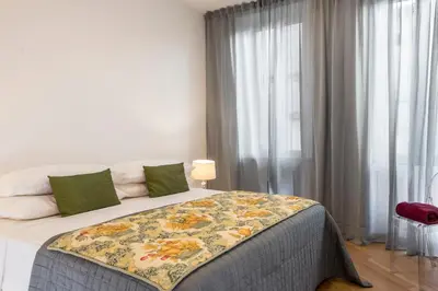 a bedroom with a bed with a floral blanket on it at Downtown_Blossom with small terrace in Rome